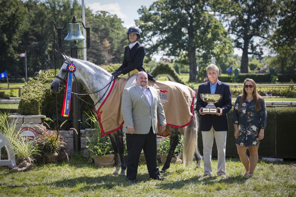 Erica Quinn and Celtic Fire joined in their winning presentation by Nicholas Walker of Canadian Pacific, Bill Rube of the USHJA Foundation and Maggie Schraeder of Rider's Boutique. Photo by Aullmyn Photography